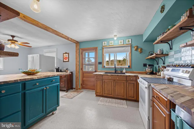 a kitchen with sink stove and cabinets