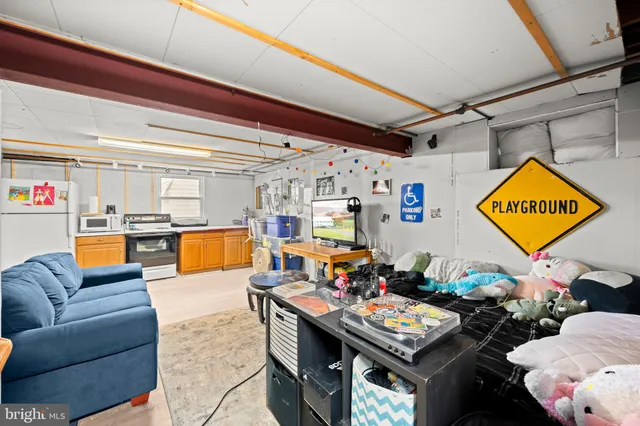 a living room with furniture and kitchen view