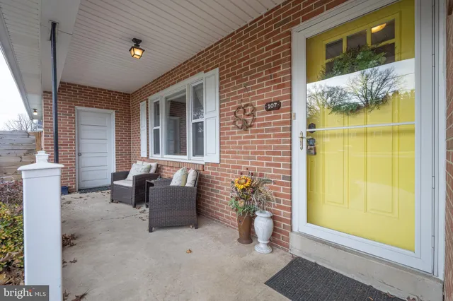 a view of a patio with chairs and potted plants
