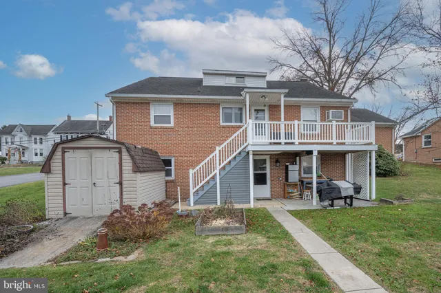 a front view of a house with a yard table and chairs
