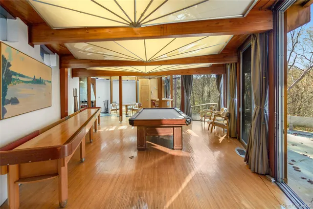 a view of a hallway with wooden floor and door