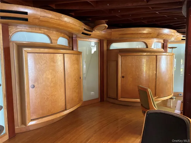 a view of a room with wooden floor and windows