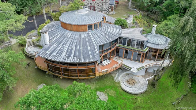 a backyard of a house with table and chairs a barbeque with potted plants