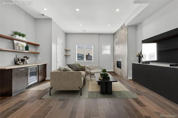 a living room with furniture and a wooden floor