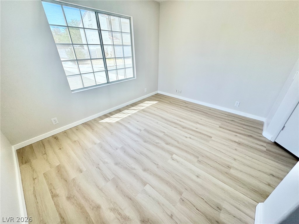 7340 Ridge Star Court Las Vegas, NV 89131 - Photo 13 of 22 Natural light illuminates this versatile room with durable laminate flooring.