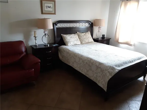 a bedroom with a bed and a couch