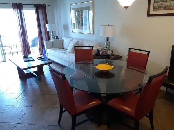 a dining room with furniture and window