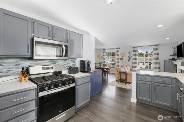 a kitchen with a sink stove and microwave
