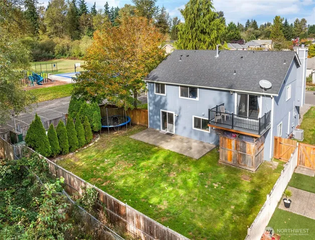 aerial view of a house with swimming pool and trees