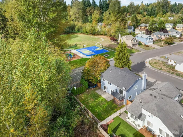 an aerial view of residential house with outdoor space and swimming pool