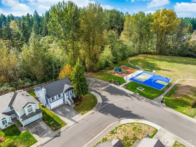 an aerial view of a house with swimming pool garden and patio