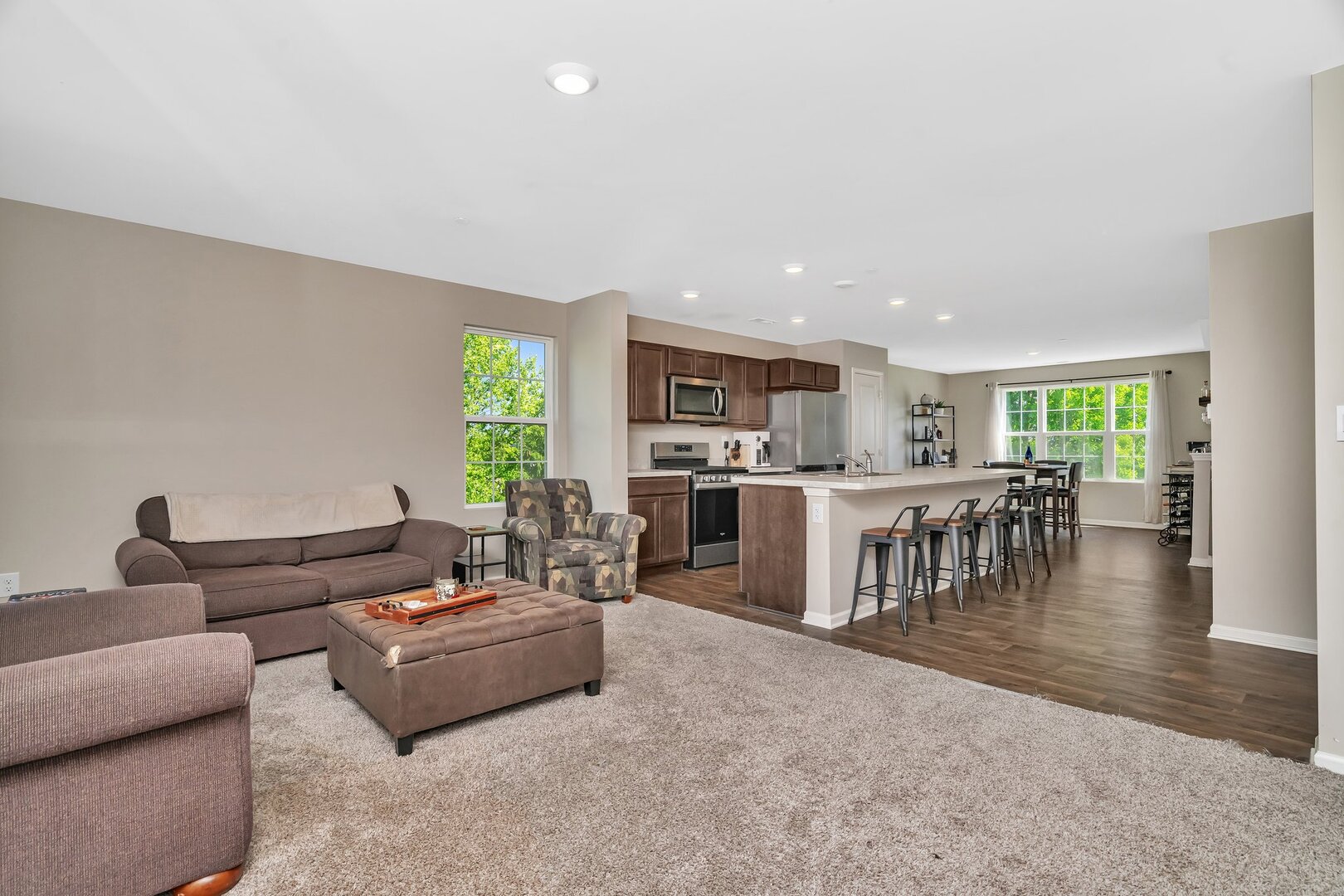 3741 Bailey Road Yorkville, IL 60560 - Photo 6 of 32 a living room with furniture and a dining table with kitchen view