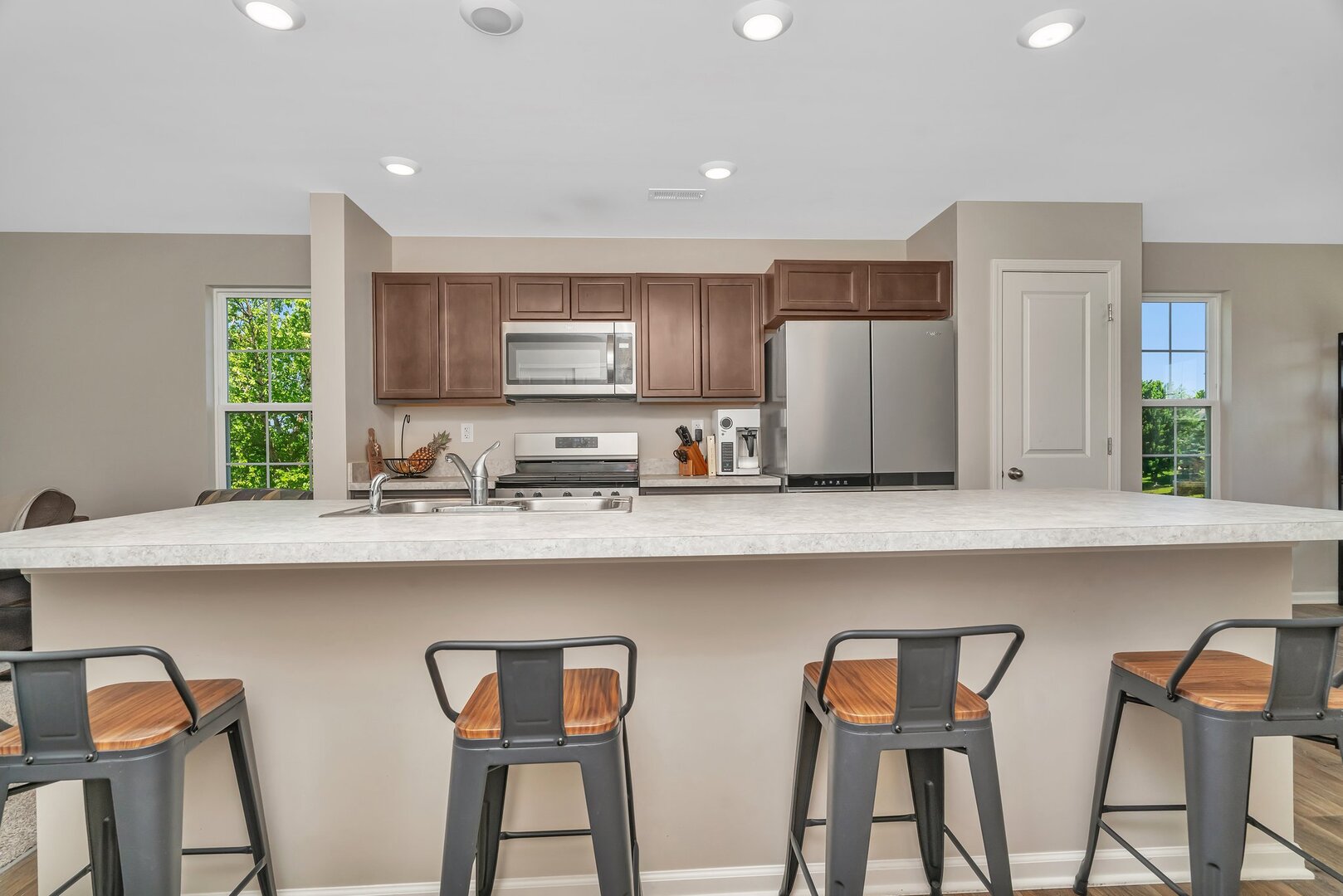 3741 Bailey Road Yorkville, IL 60560 - Photo 9 of 32 a kitchen with stainless steel appliances granite countertop a stove top oven a sink a refrigerator with white cabinets and wooden floor
