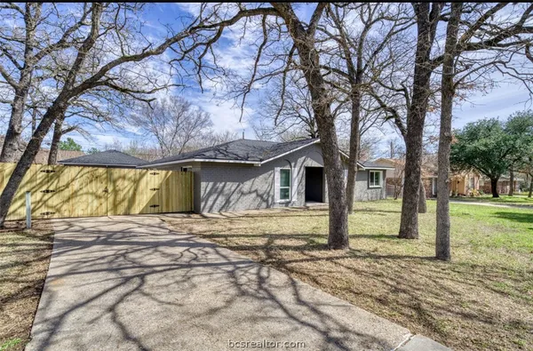 a house that has a tree in front of it