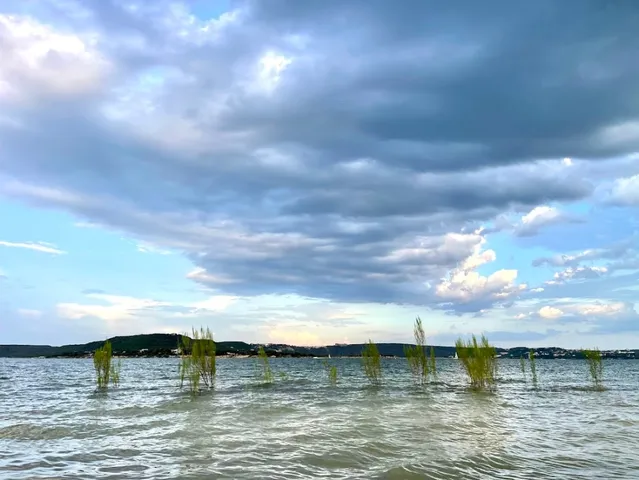 a view of a lake with houses in the back