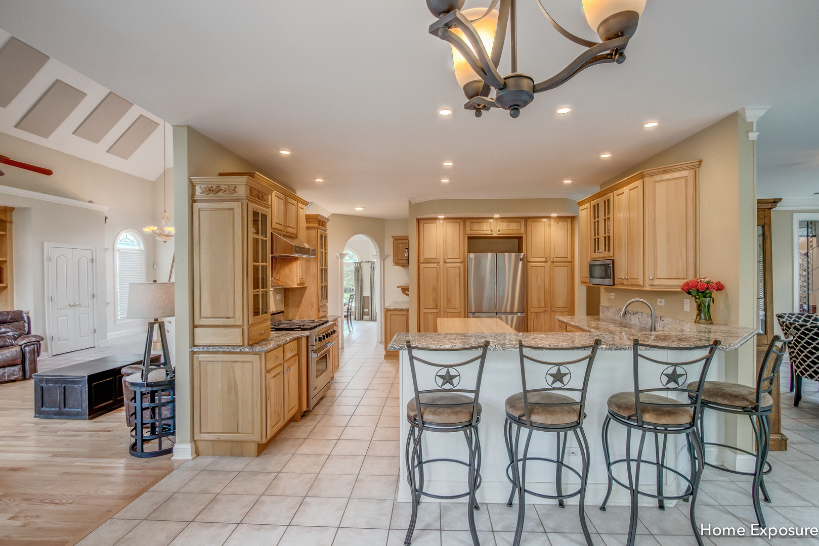 2552 Sutton Lane Aurora, IL 60502 - Photo 12 of 57 a kitchen with stainless steel appliances kitchen island granite countertop a dining table chairs and a refrigerator