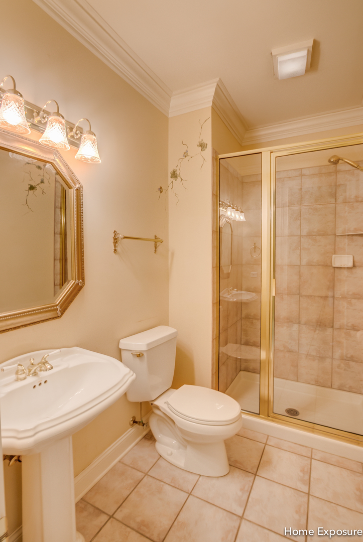 2552 Sutton Lane Aurora, IL 60502 - Photo 19 of 57 a bathroom with a sink a toilet and shower