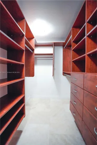 a view of walk in closet with empty racks