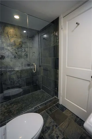a bathroom with a shower and a sink