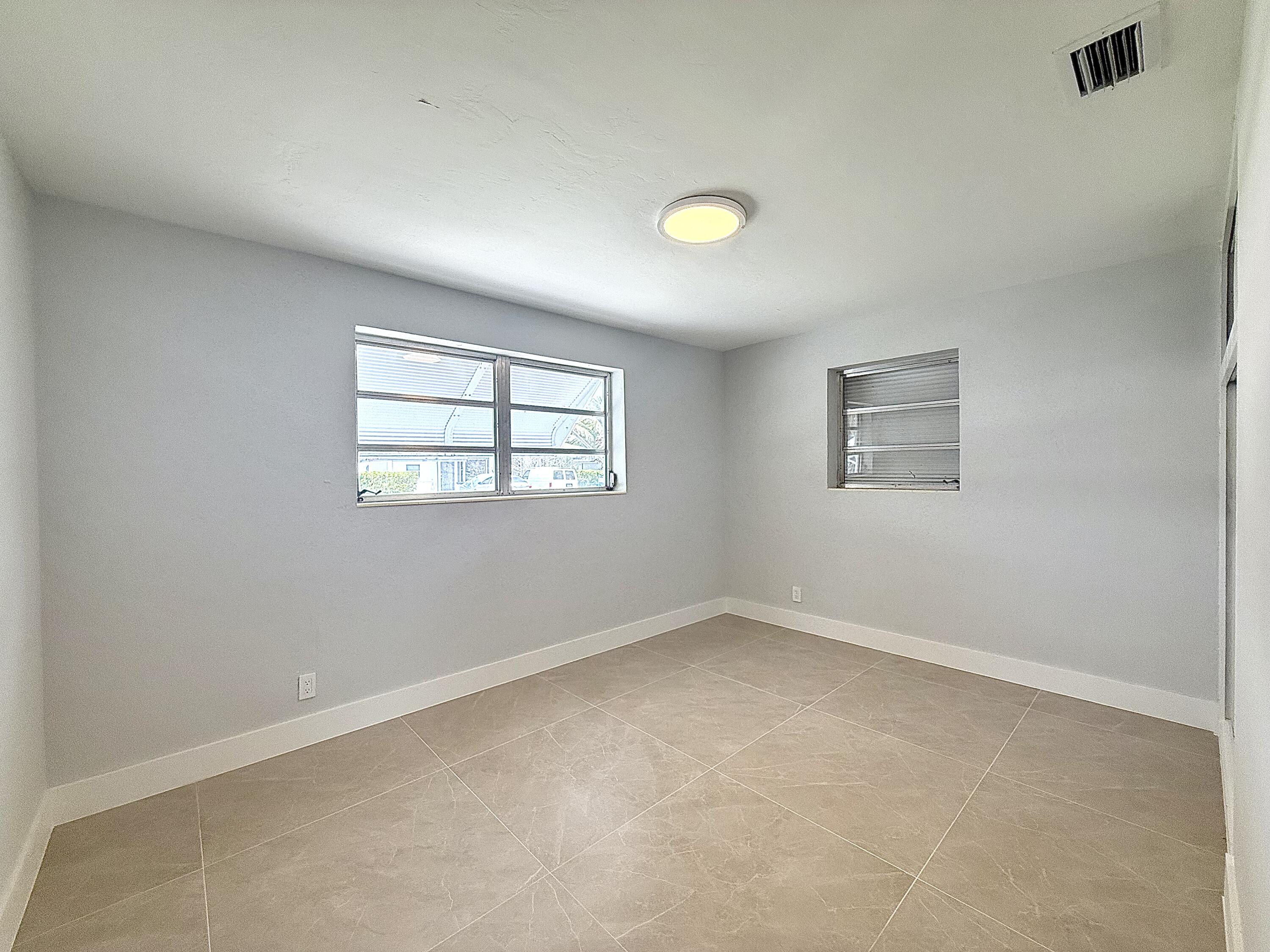 2018 Whitney Road West Palm Beach, FL 33409 - Photo 4 of 11 an empty room with windows