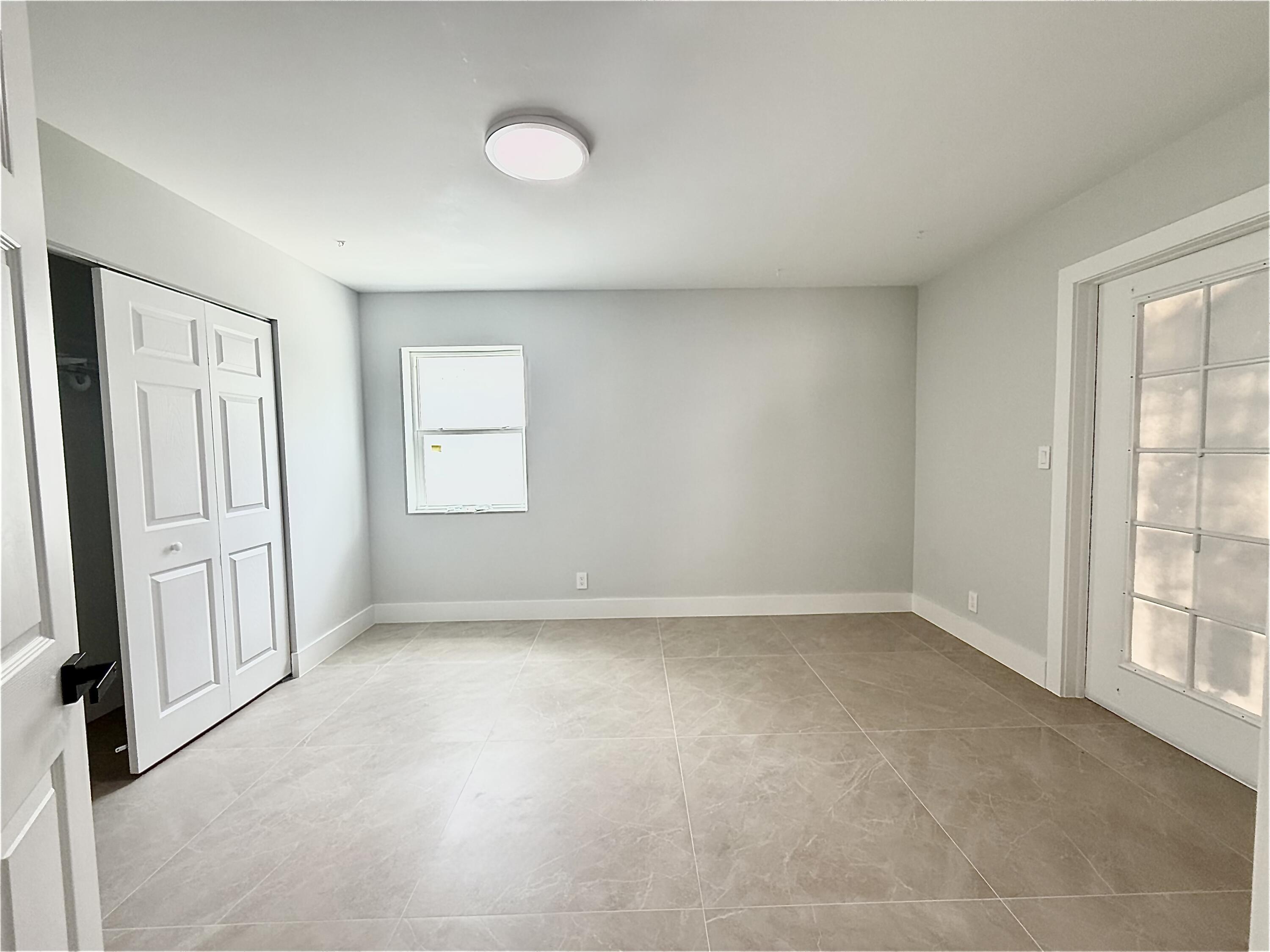 2018 Whitney Road West Palm Beach, FL 33409 - Photo 6 of 11 an empty room with windows
