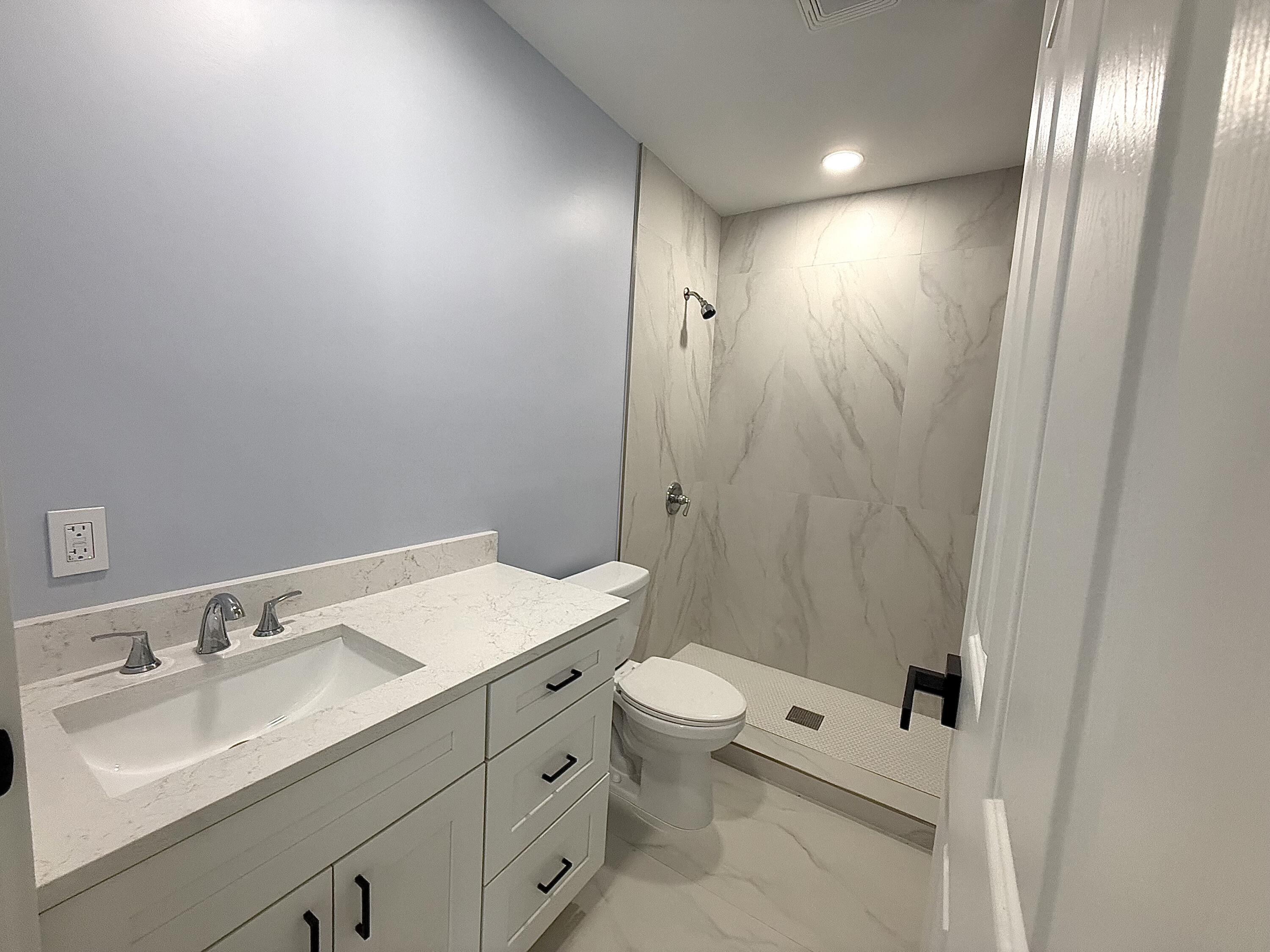2018 Whitney Road West Palm Beach, FL 33409 - Photo 8 of 11 a bathroom with a sink toilet and shower