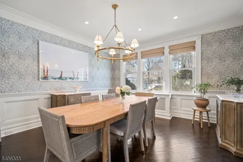 a kitchen with stainless steel appliances granite countertop a stove a sink a microwave a refrigerator and cabinets