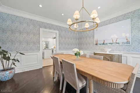 a kitchen with stainless steel appliances granite countertop a stove and white cabinets