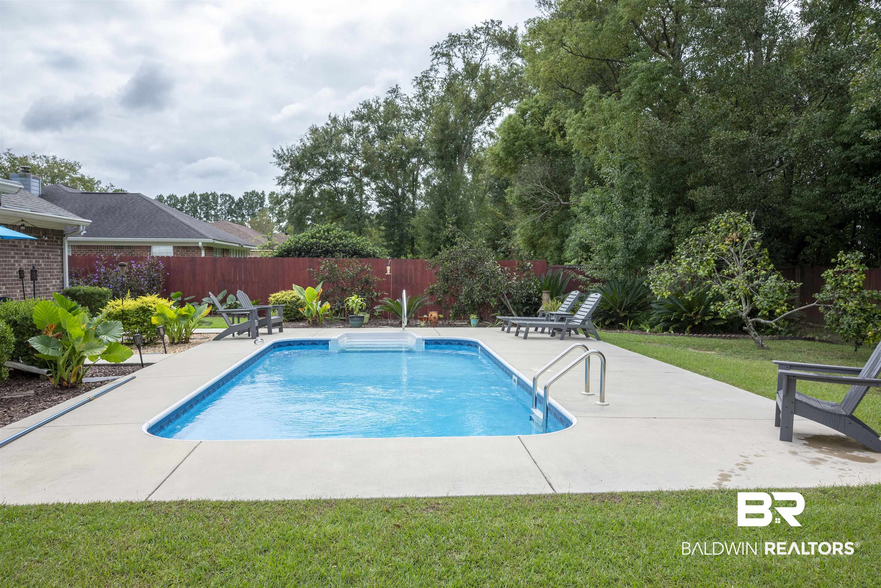 808 Wisteria Lane Foley, AL 36535 - Photo 18 of 19 View of pool featuring a yard and a patio