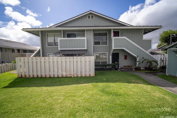 a front view of a house with a yard and porch