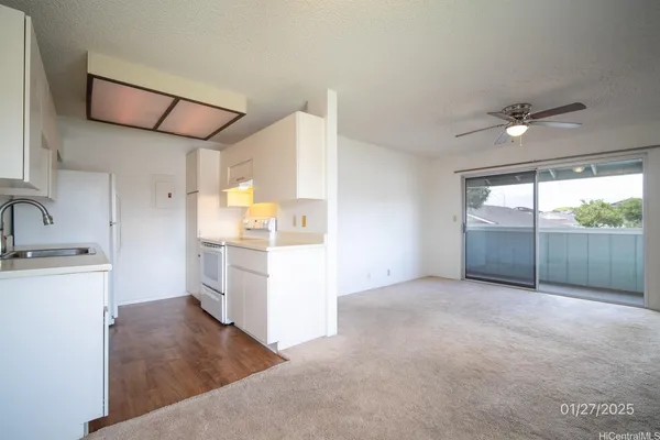 a view of a kitchen with a sink and a window