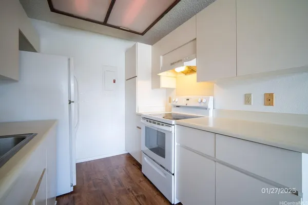 a kitchen with stainless steel appliances a sink cabinets and a window