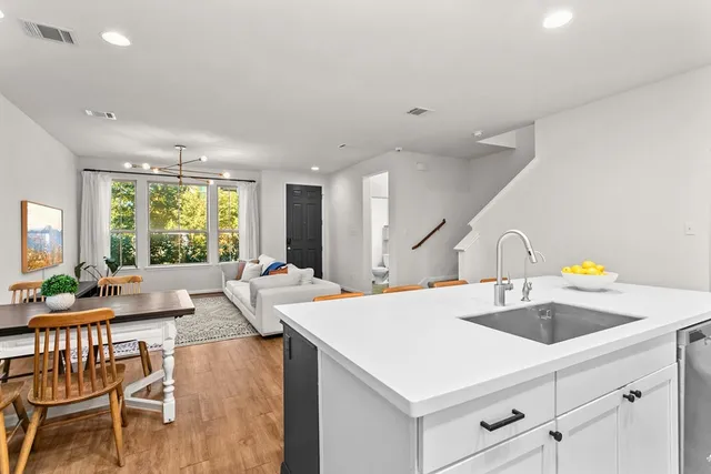 a view of a kitchen with center island and stainless steel appliances