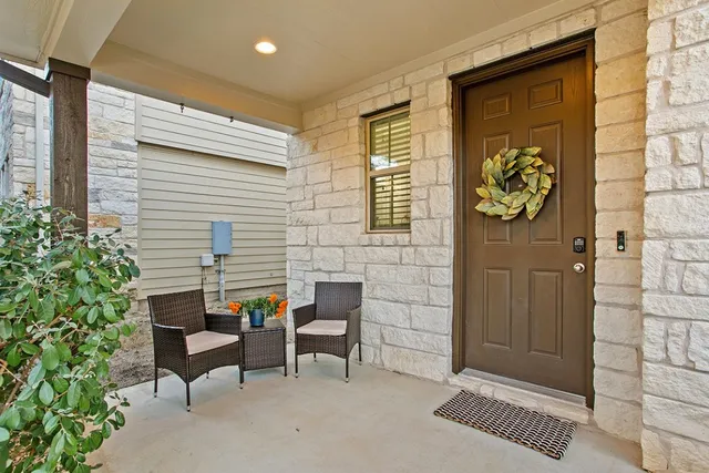 a kitchen with a table chairs and white cabinets