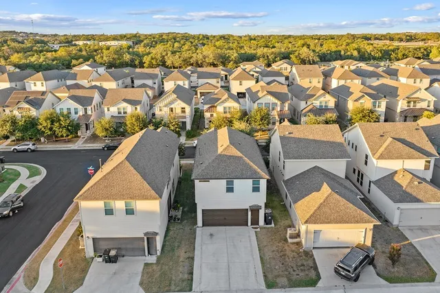 an aerial view of a house with a swimming pool and outdoor space