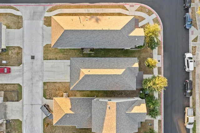 an aerial view of residential houses with outdoor space
