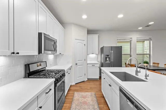 a kitchen with a sink a stove and refrigerator