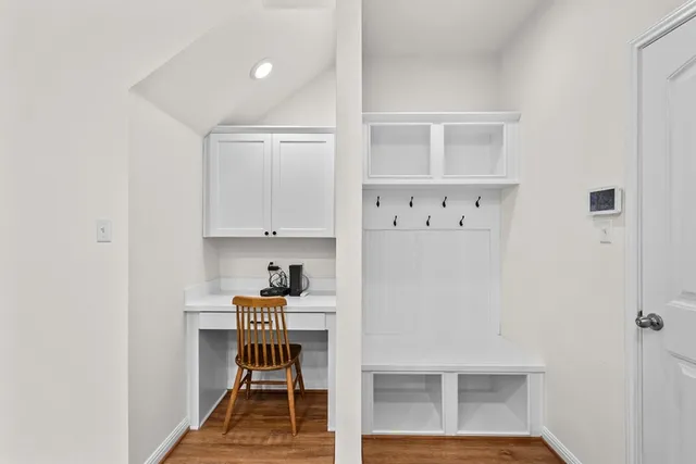a room with furniture a rug and white walls
