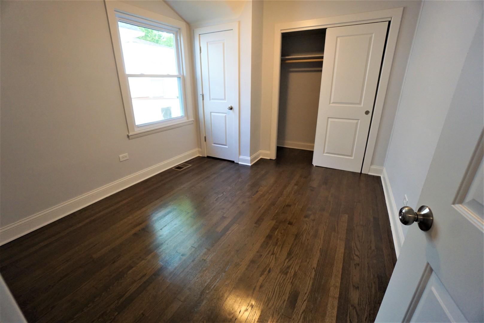 2224 Foster Street Evanston, IL 60201 - Photo 11 of 39 an empty room with wooden floor and windows