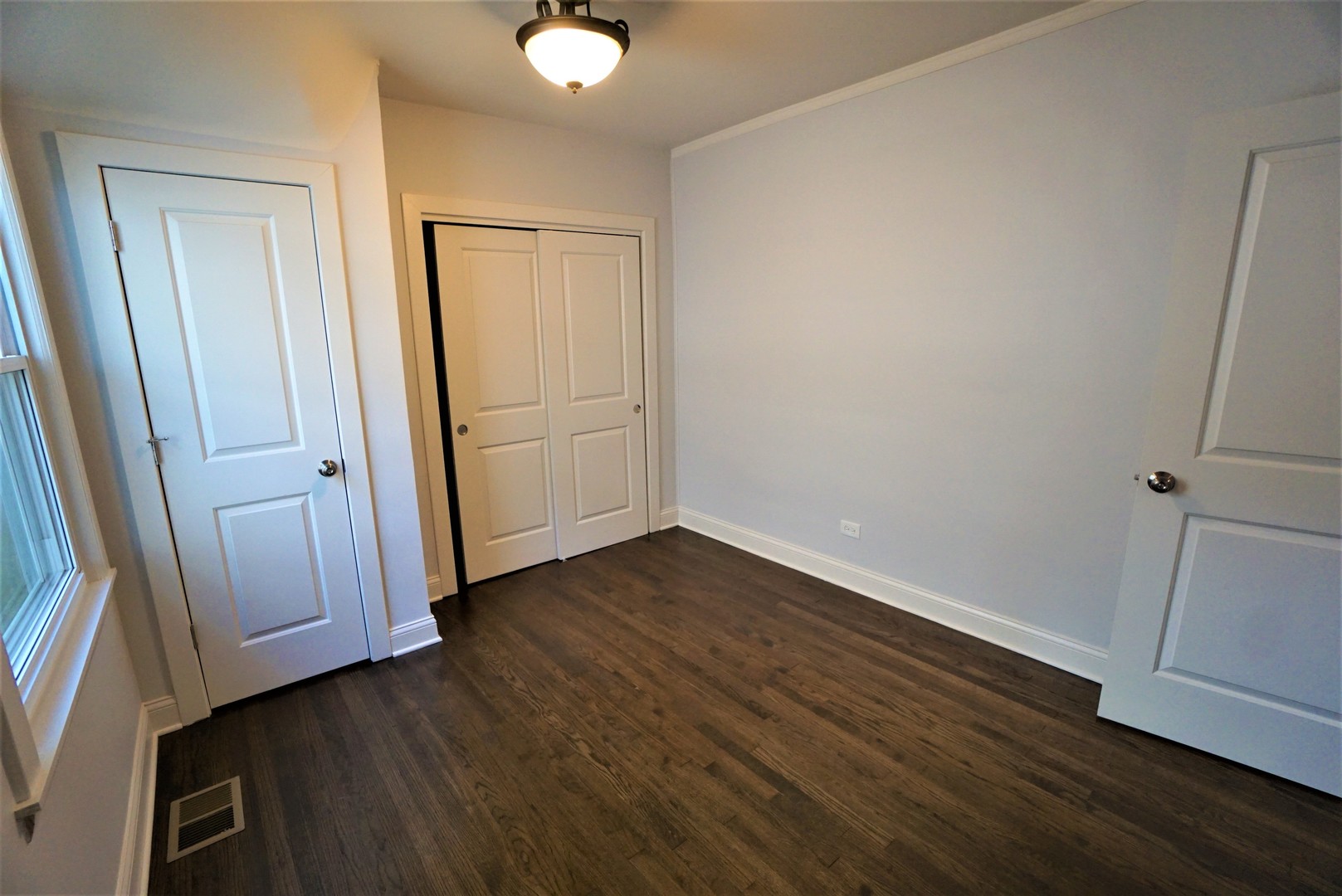 2224 Foster Street Evanston, IL 60201 - Photo 12 of 39 an empty room with wooden floor and mirror