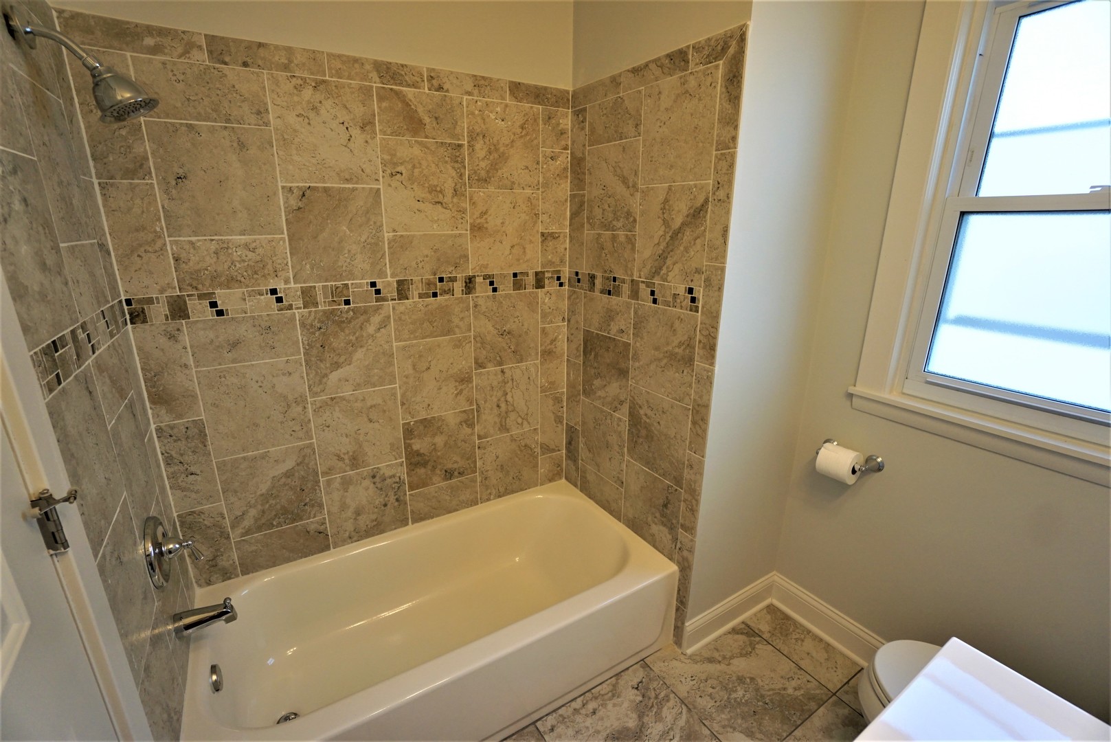 2224 Foster Street Evanston, IL 60201 - Photo 15 of 39 a bathroom with a bathtub and shower