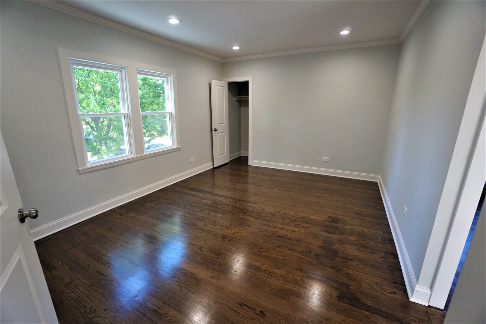2224 Foster Street Evanston, IL 60201 - Photo 19 of 39 an empty room with wooden floor and windows
