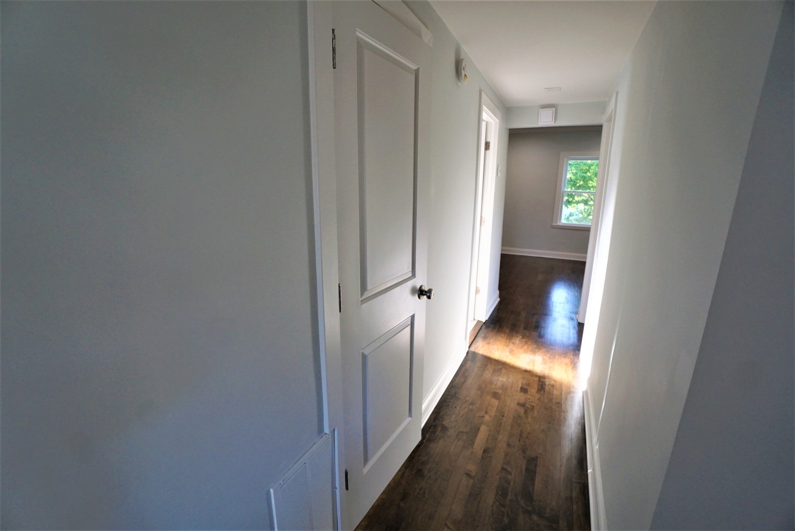 2224 Foster Street Evanston, IL 60201 - Photo 21 of 39 a view of a hallway with wooden floor and a bathroom