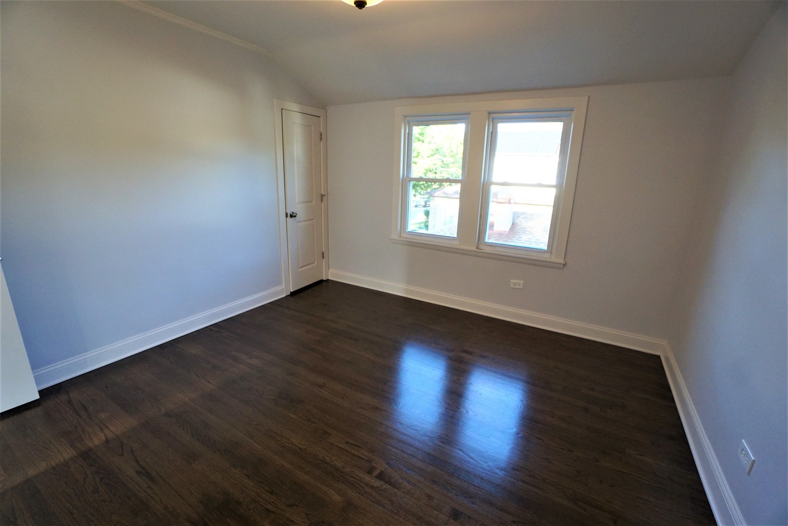 2224 Foster Street Evanston, IL 60201 - Photo 22 of 39 an empty room with wooden floor and windows
