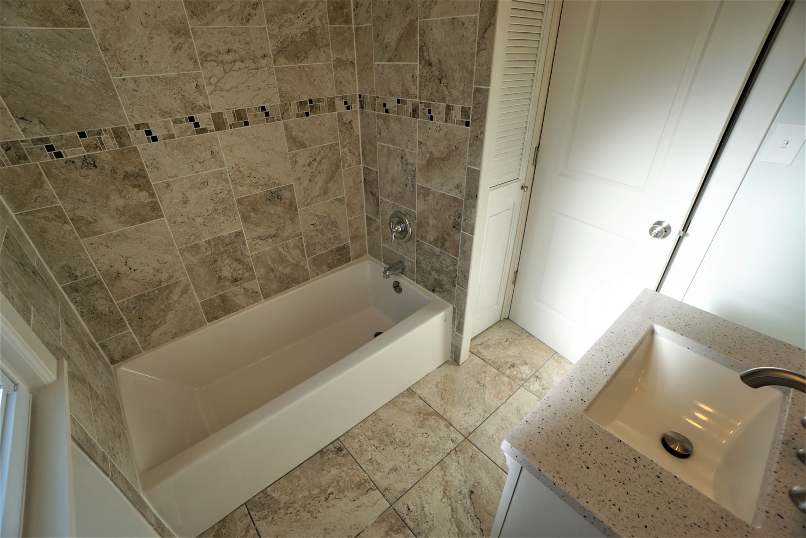 2224 Foster Street Evanston, IL 60201 - Photo 25 of 39 a bathroom with a tub and shower
