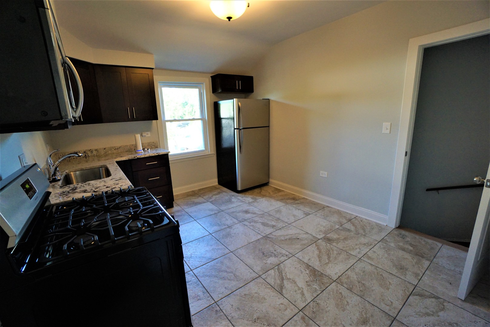 2224 Foster Street Evanston, IL 60201 - Photo 30 of 39 a kitchen with stainless steel appliances granite countertop a refrigerator and a stove top oven