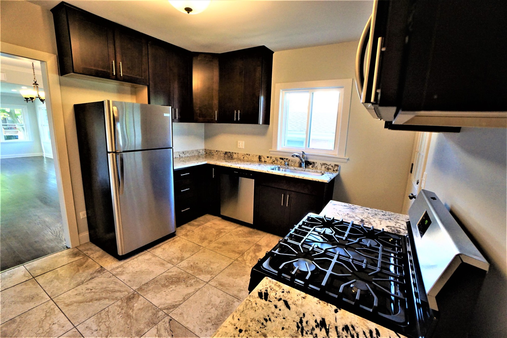 2224 Foster Street Evanston, IL 60201 - Photo 8 of 39 a kitchen with stainless steel appliances a stove a sink and a refrigerator