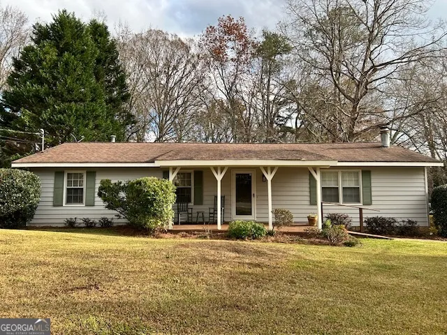 a front view of house with yard and green space