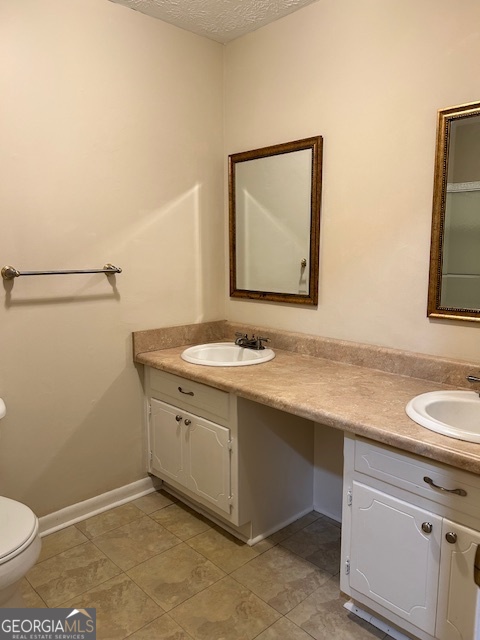 1366 Zebulon Road Griffin, GA 30224 - Photo 5 of 12 a bathroom with a toilet sink and mirror