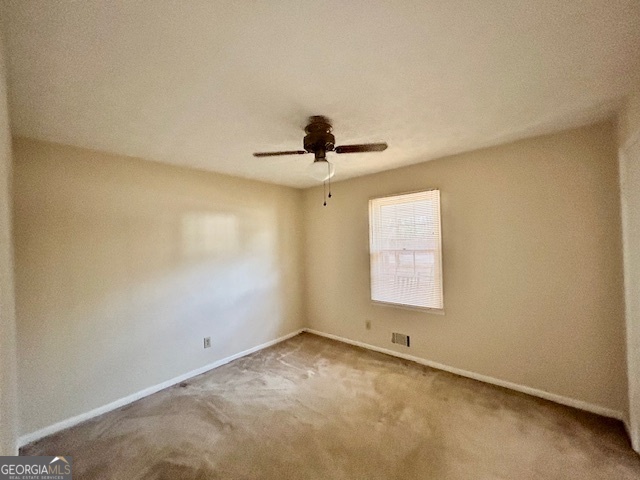1366 Zebulon Road Griffin, GA 30224 - Photo 6 of 12 an empty room with a window and a ceiling fan